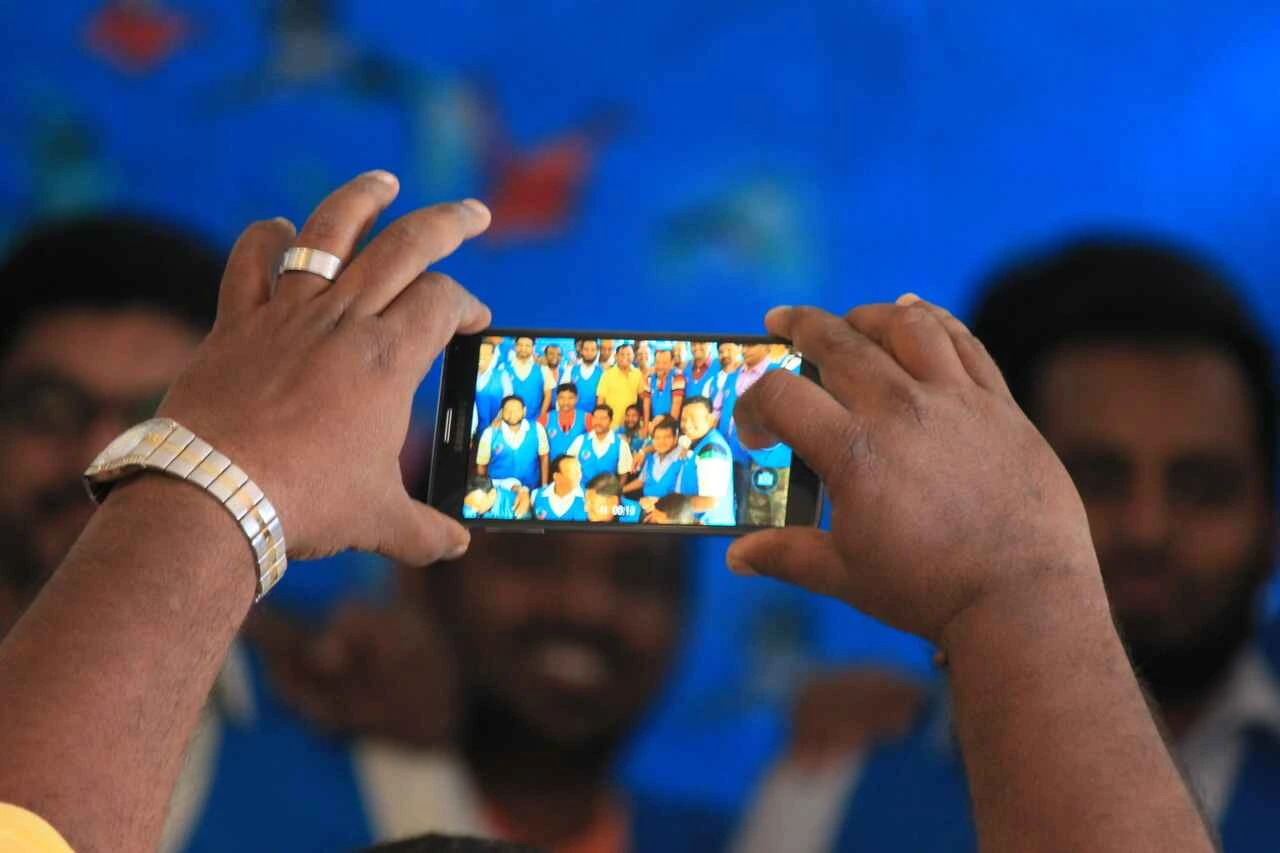 Large group photo of silver jubilee batch at a university homecoming event